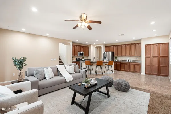 a living room with furniture kitchen and a table