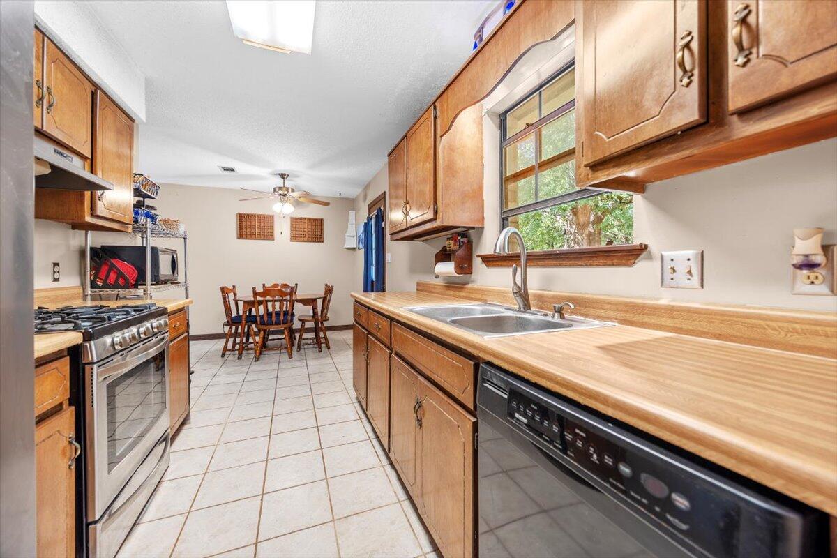 5351 Highway 4 Baker, FL 32531 - Photo 7 of 9 a kitchen with stainless steel appliances granite countertop a stove and a sink