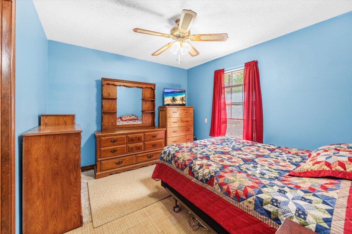 5351 Highway 4 Baker, FL 32531 - Photo 8 of 9 a bedroom with a bed and a chandelier