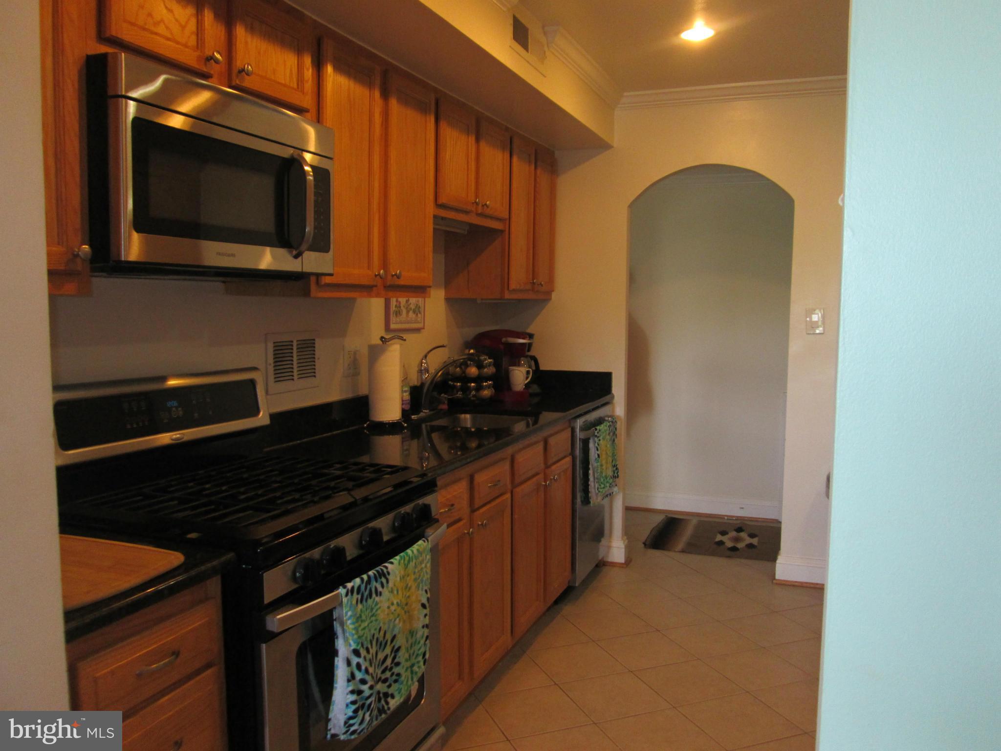 3100 South Manchester Street, Unit 727 Falls Church, VA 22044 - Photo 1 of 23 a kitchen with a stove and a microwave