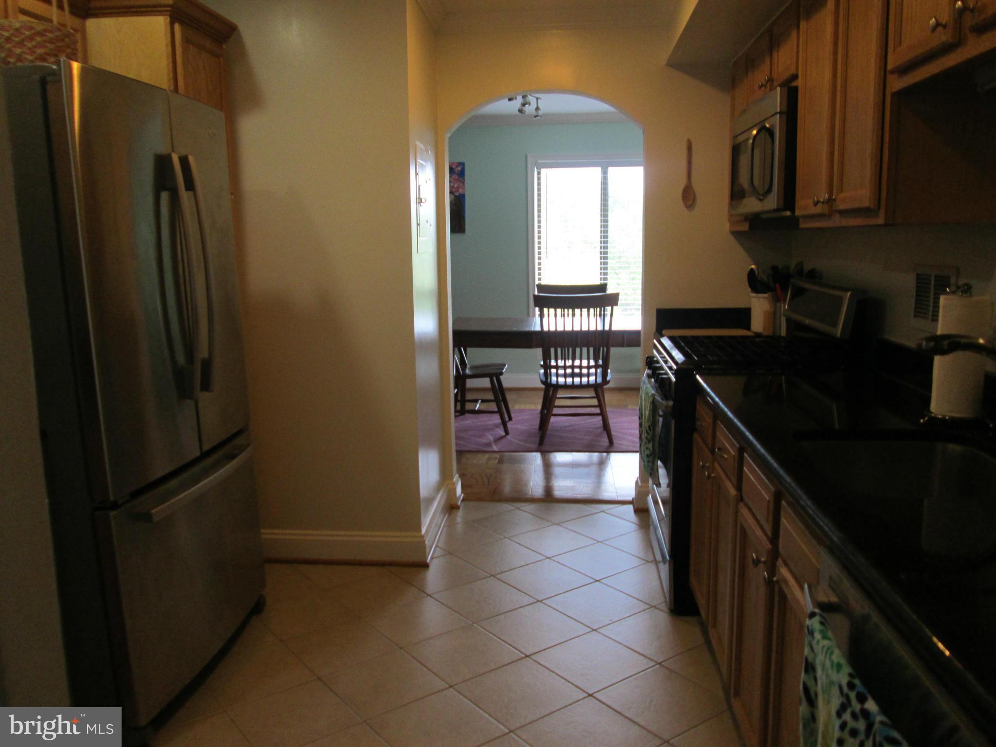 3100 South Manchester Street, Unit 727 Falls Church, VA 22044 - Photo 2 of 23 a kitchen with granite countertop a refrigerator a stove and a sink