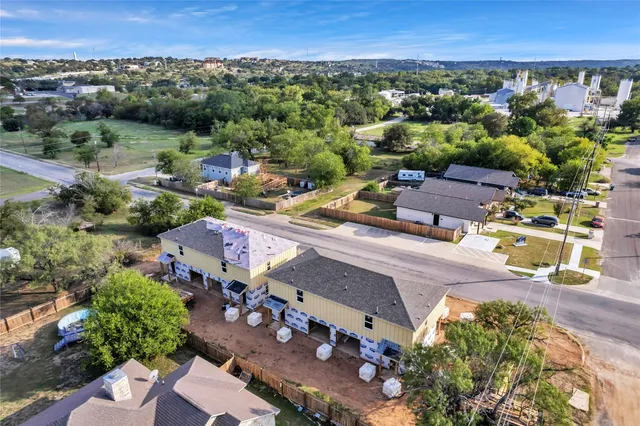 an aerial view of a house with a yard