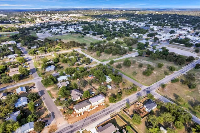 an aerial view of residential houses with outdoor space