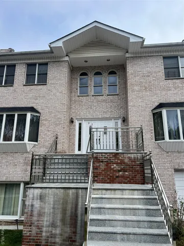 a front view of a house with stairs