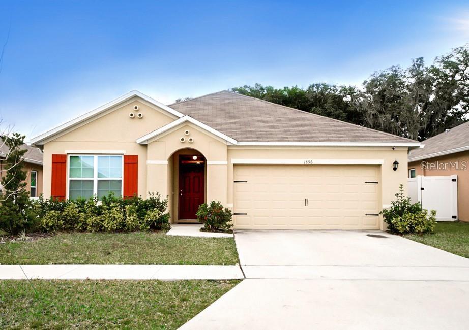 1896 Hickory Bluff Road Kissimmee, FL 34744 - Photo 1 of 1 a front view of a house with garden