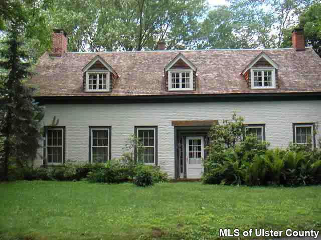 209 Tongore Road Stone Ridge, NY 12484 - Photo 5 of 6 a front view of a house with a garden