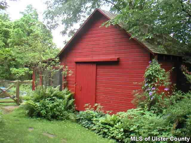 209 Tongore Road Stone Ridge, NY 12484 - Photo 6 of 6 a view of a backyard with plants and large tree