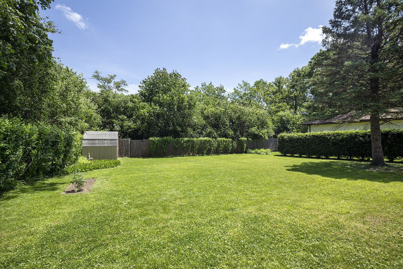 1001 Longaker Road Northbrook, IL 60062 - Photo 16 of 17 a backyard of a house with plants and large trees