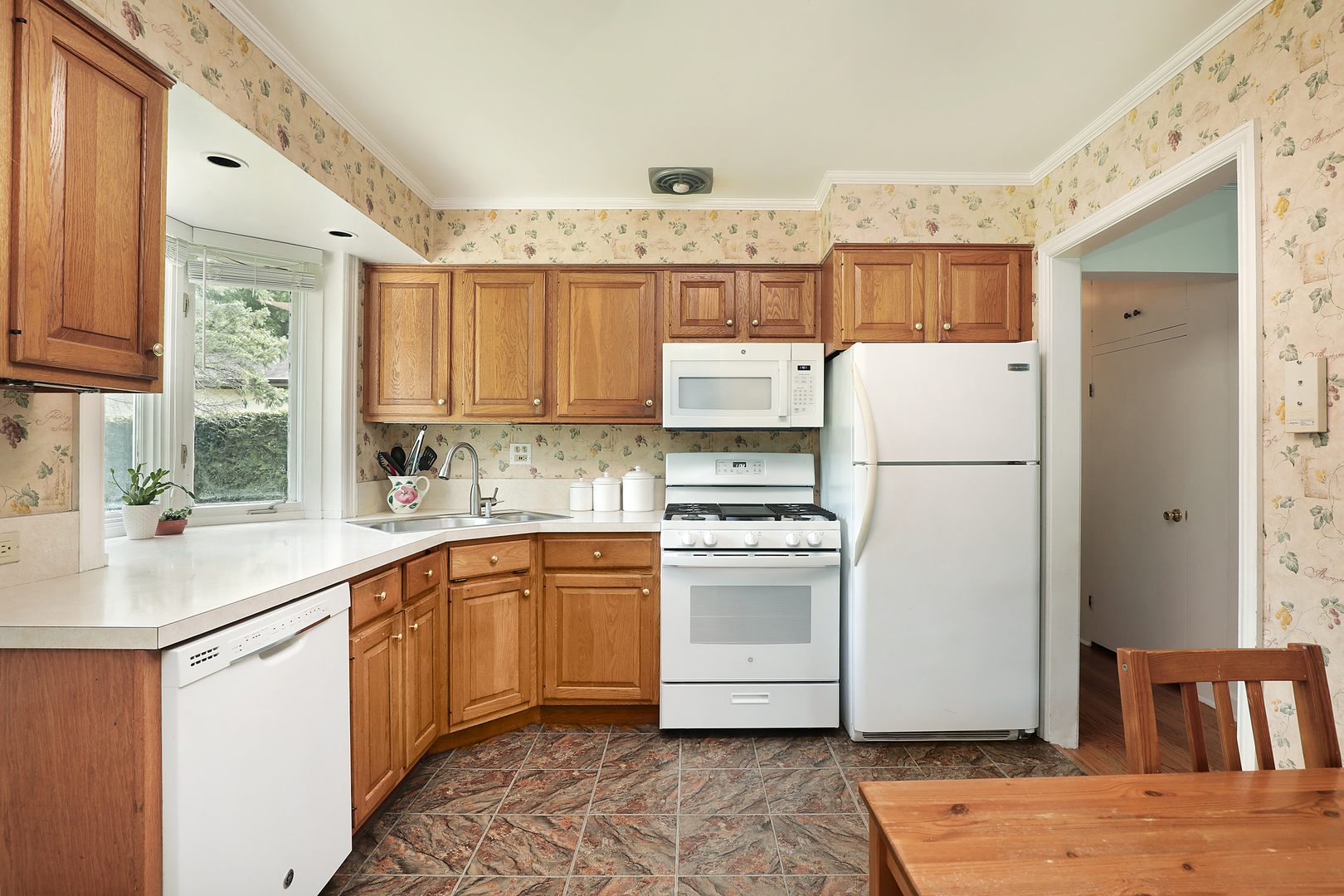 1001 Longaker Road Northbrook, IL 60062 - Photo 5 of 17 a kitchen with stainless steel appliances granite countertop a refrigerator sink and white cabinets