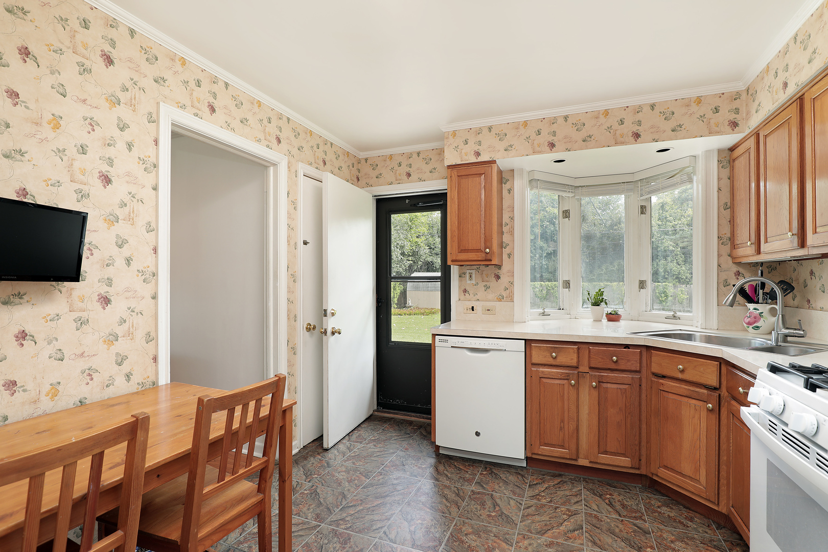 1001 Longaker Road Northbrook, IL 60062 - Photo 6 of 17 a kitchen with stainless steel appliances kitchen island granite countertop a sink and wooden cabinets