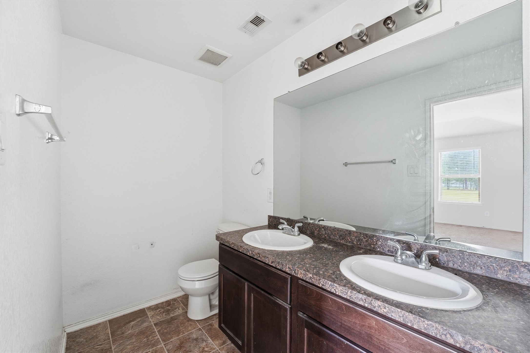 1634 Road 5102 Cleveland, TX 77327 - Photo 14 of 21 a bathroom with a granite countertop sink a toilet and a mirror