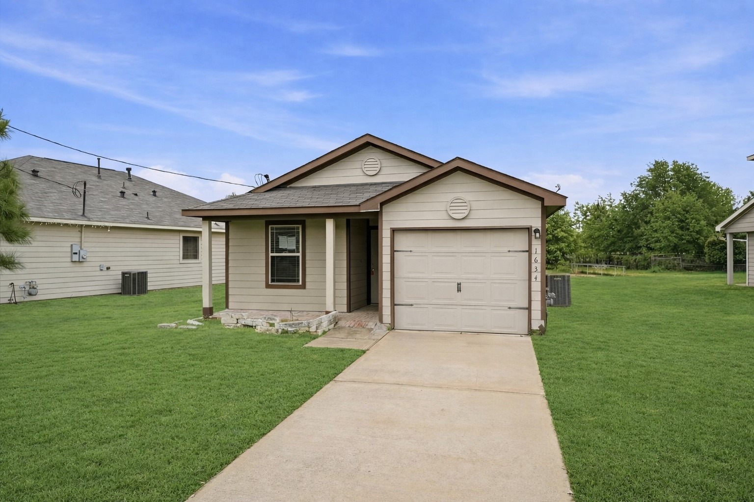 1634 Road 5102 Cleveland, TX 77327 - Photo 2 of 21 a front view of a house with a garden and yard