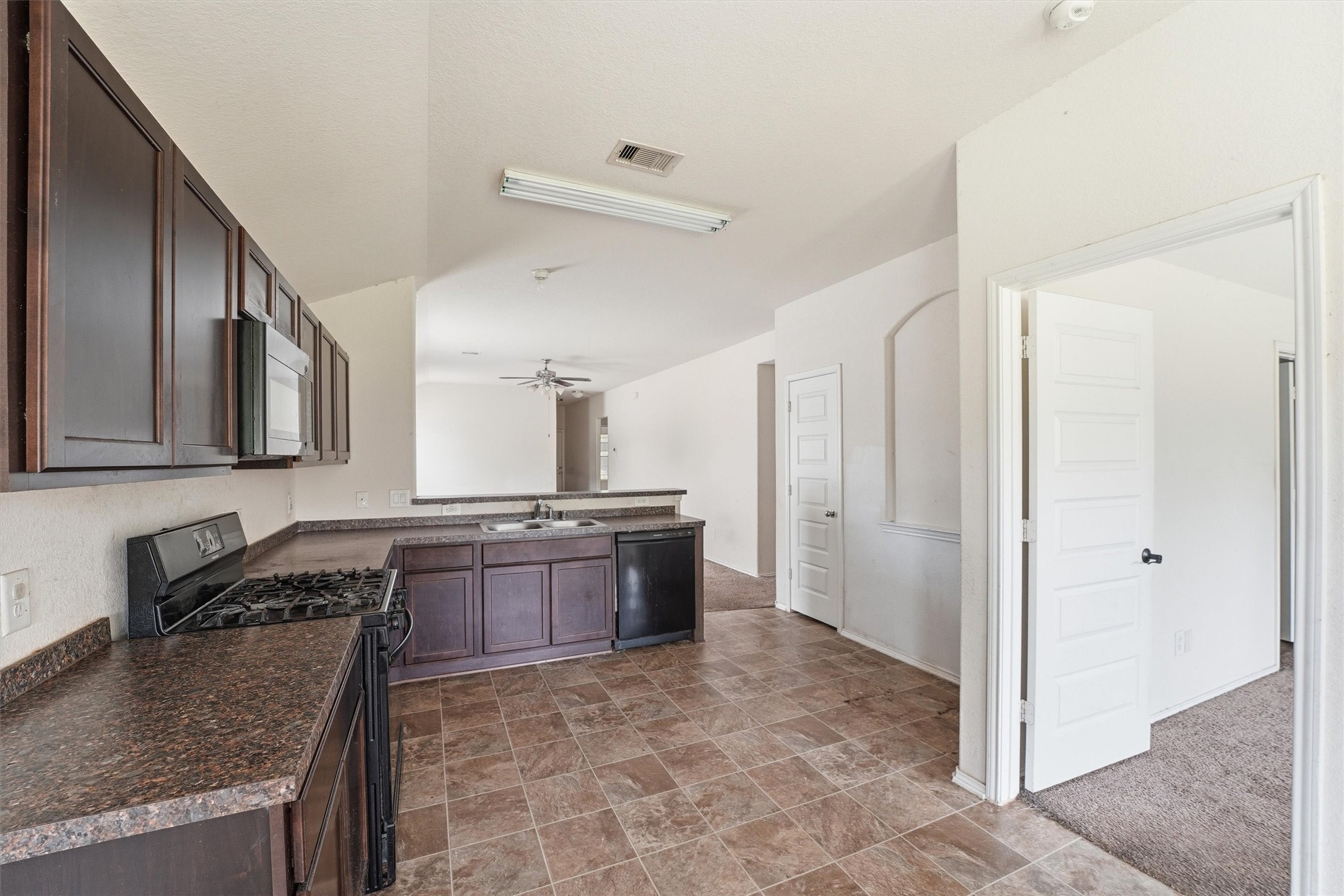 1634 Road 5102 Cleveland, TX 77327 - Photo 9 of 21 a large kitchen with granite countertop a sink and a refrigerator