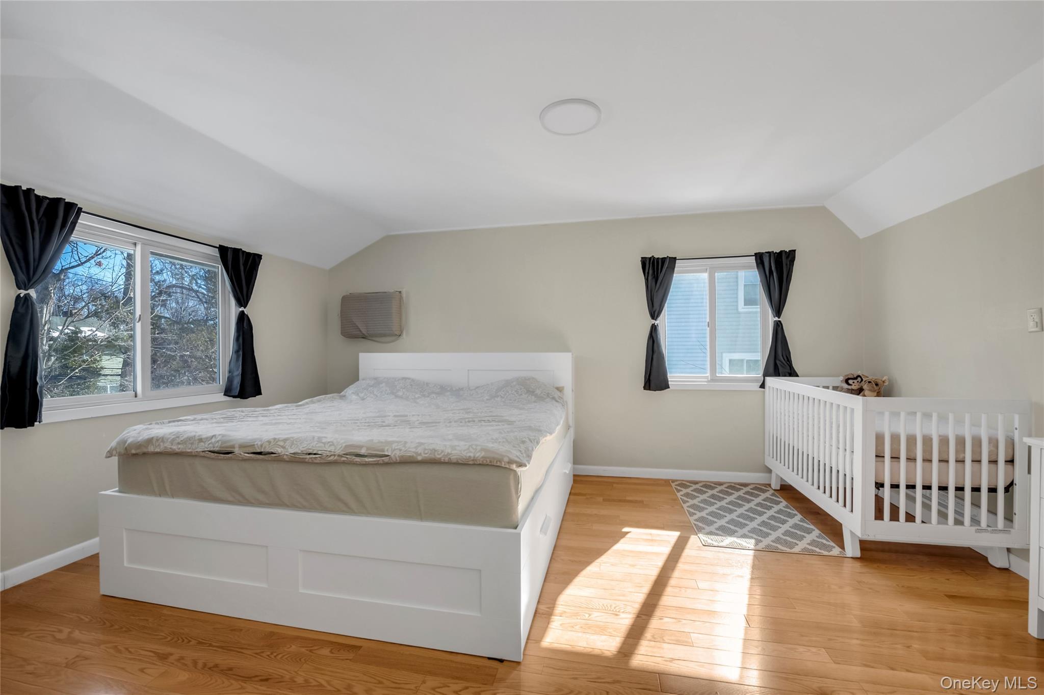 34 Roxbury Road Port Washington, NY 11050 - Photo 12 of 18 a bedroom with a bed and a window