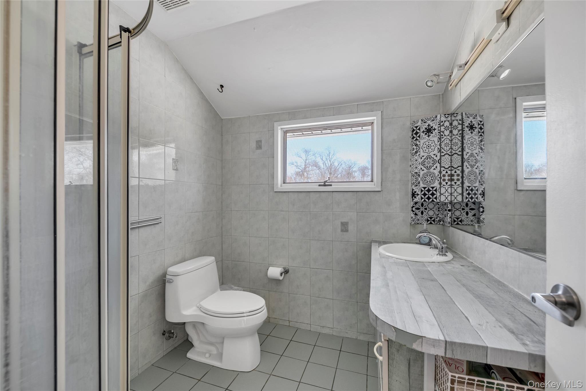 34 Roxbury Road Port Washington, NY 11050 - Photo 15 of 18 a bathroom with a toilet sink and shower