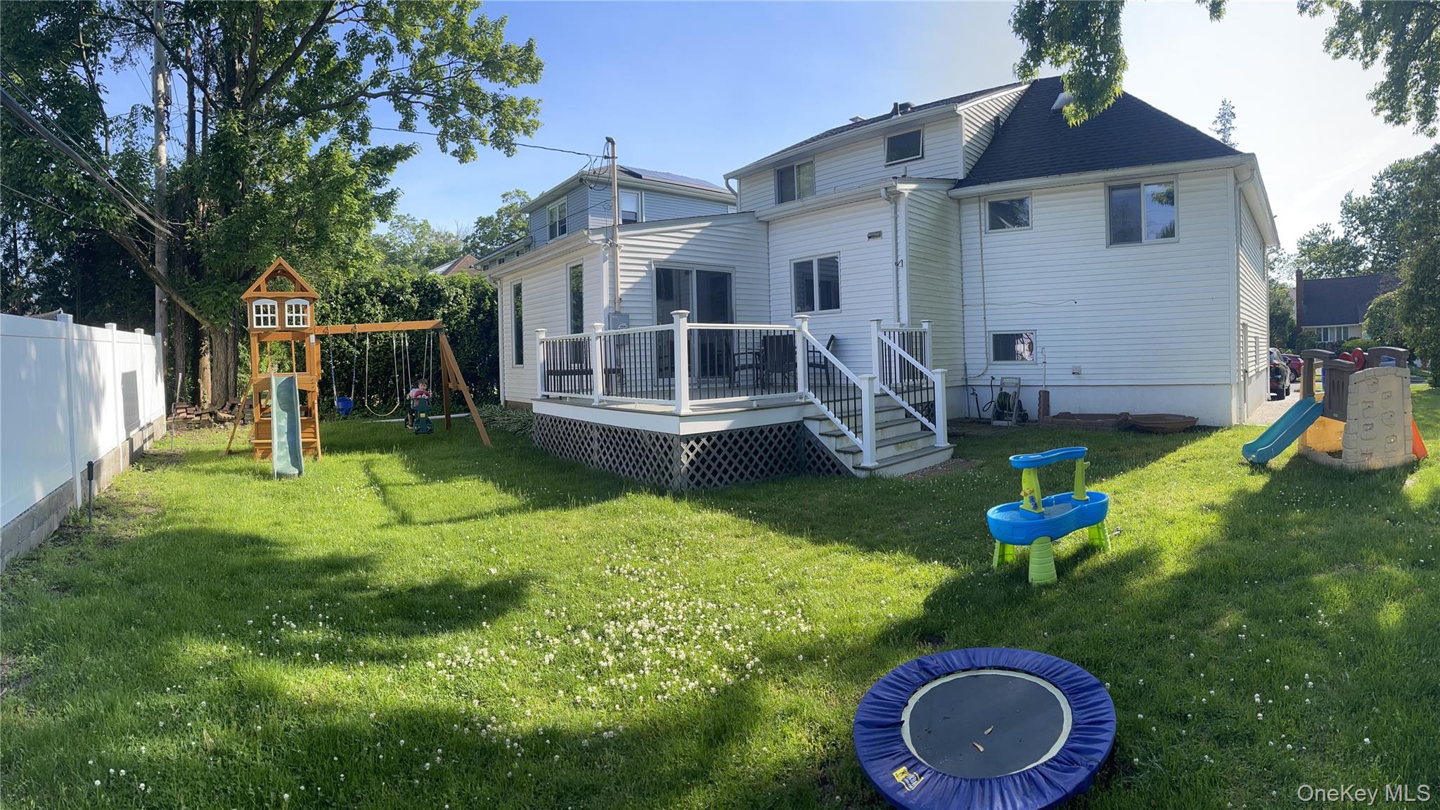 34 Roxbury Road Port Washington, NY 11050 - Photo 18 of 18 a house with garden in front of it