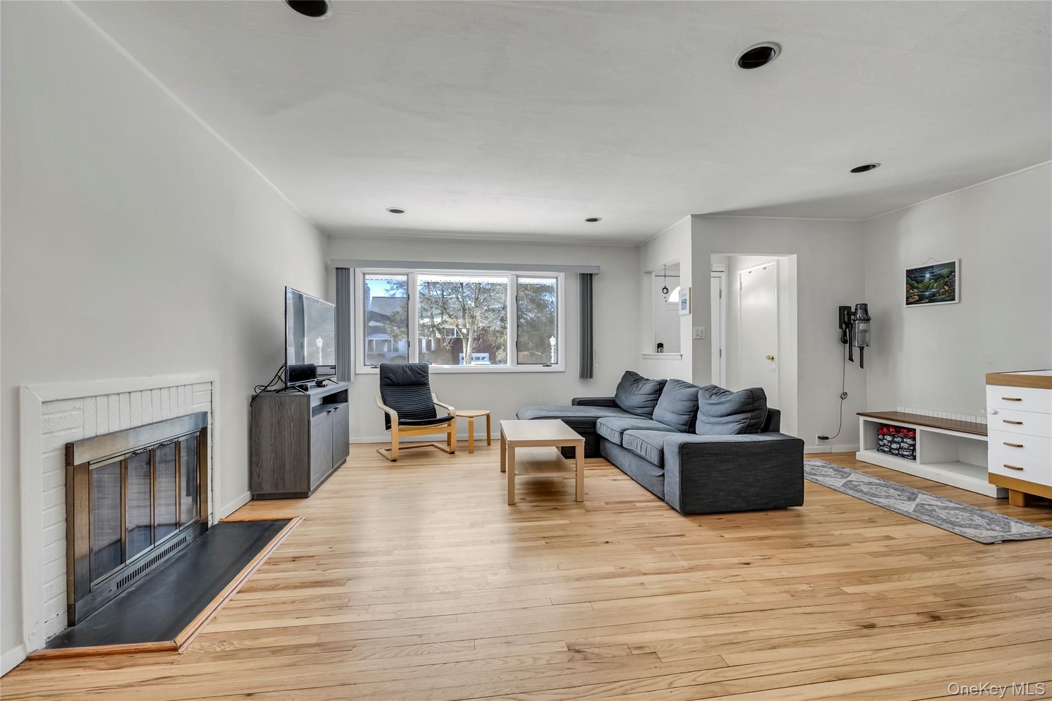 34 Roxbury Road Port Washington, NY 11050 - Photo 3 of 18 a living room with furniture and a fireplace