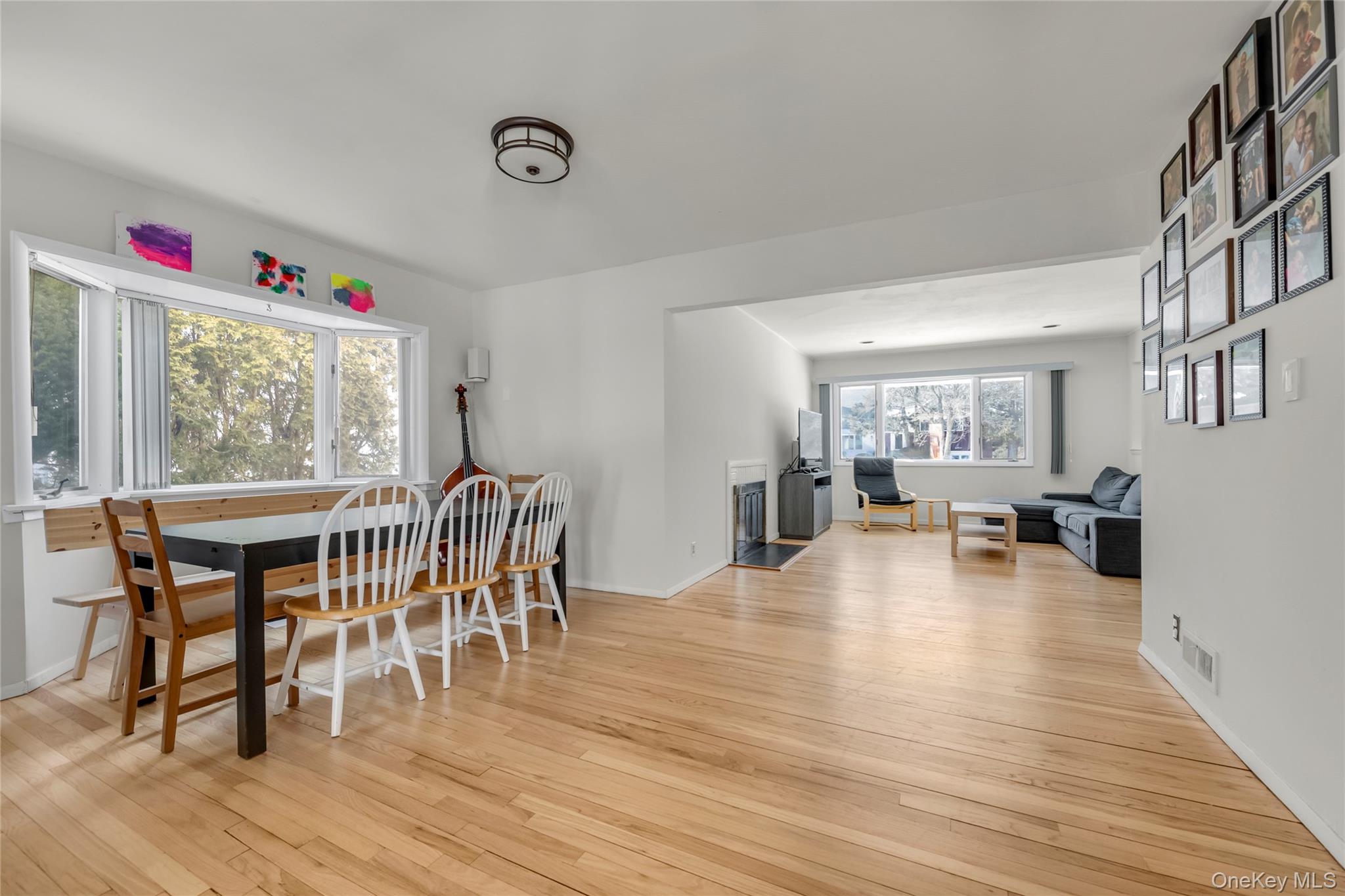 34 Roxbury Road Port Washington, NY 11050 - Photo 4 of 18 a view of a dining room with furniture and wooden floor