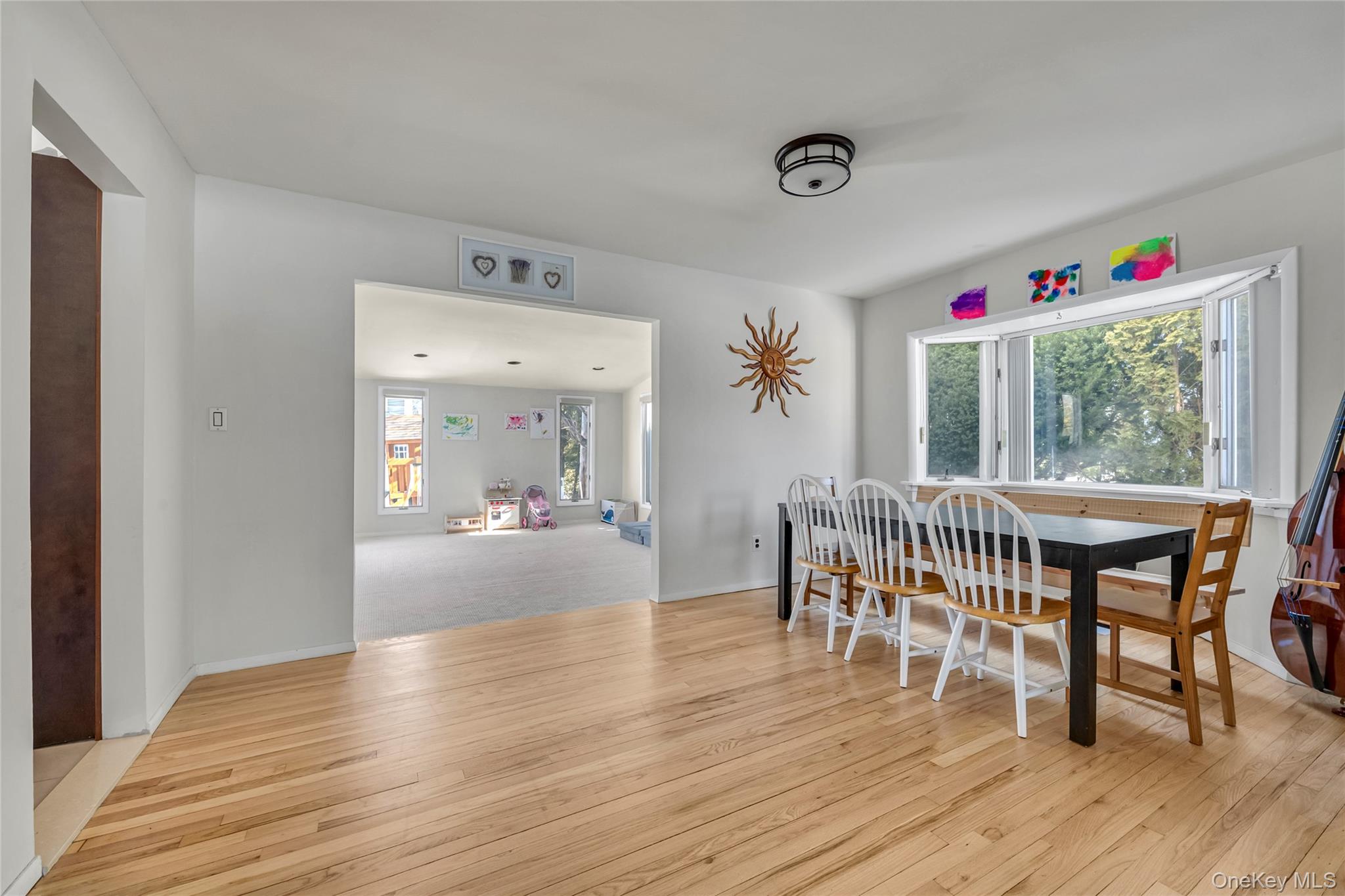 34 Roxbury Road Port Washington, NY 11050 - Photo 5 of 18 a view of a dining room with furniture window and wooden floor