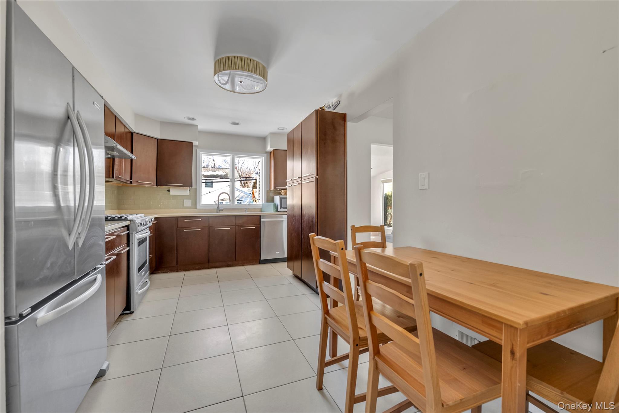34 Roxbury Road Port Washington, NY 11050 - Photo 6 of 18 a kitchen with cabinets and stainless steel appliances