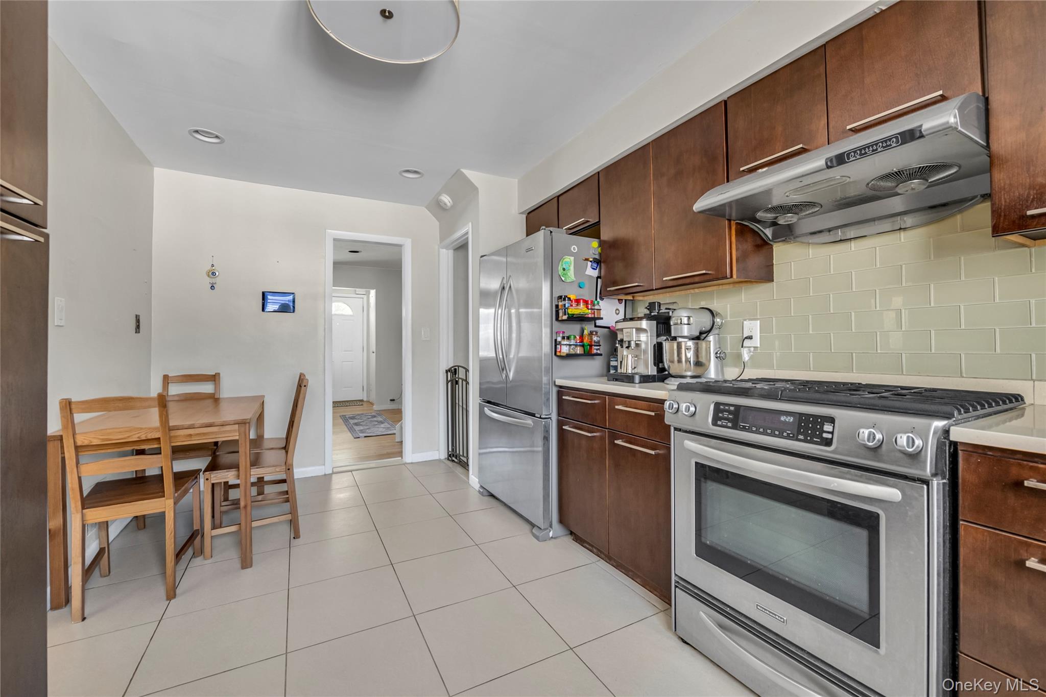 34 Roxbury Road Port Washington, NY 11050 - Photo 7 of 18 a kitchen with cabinets and appliances