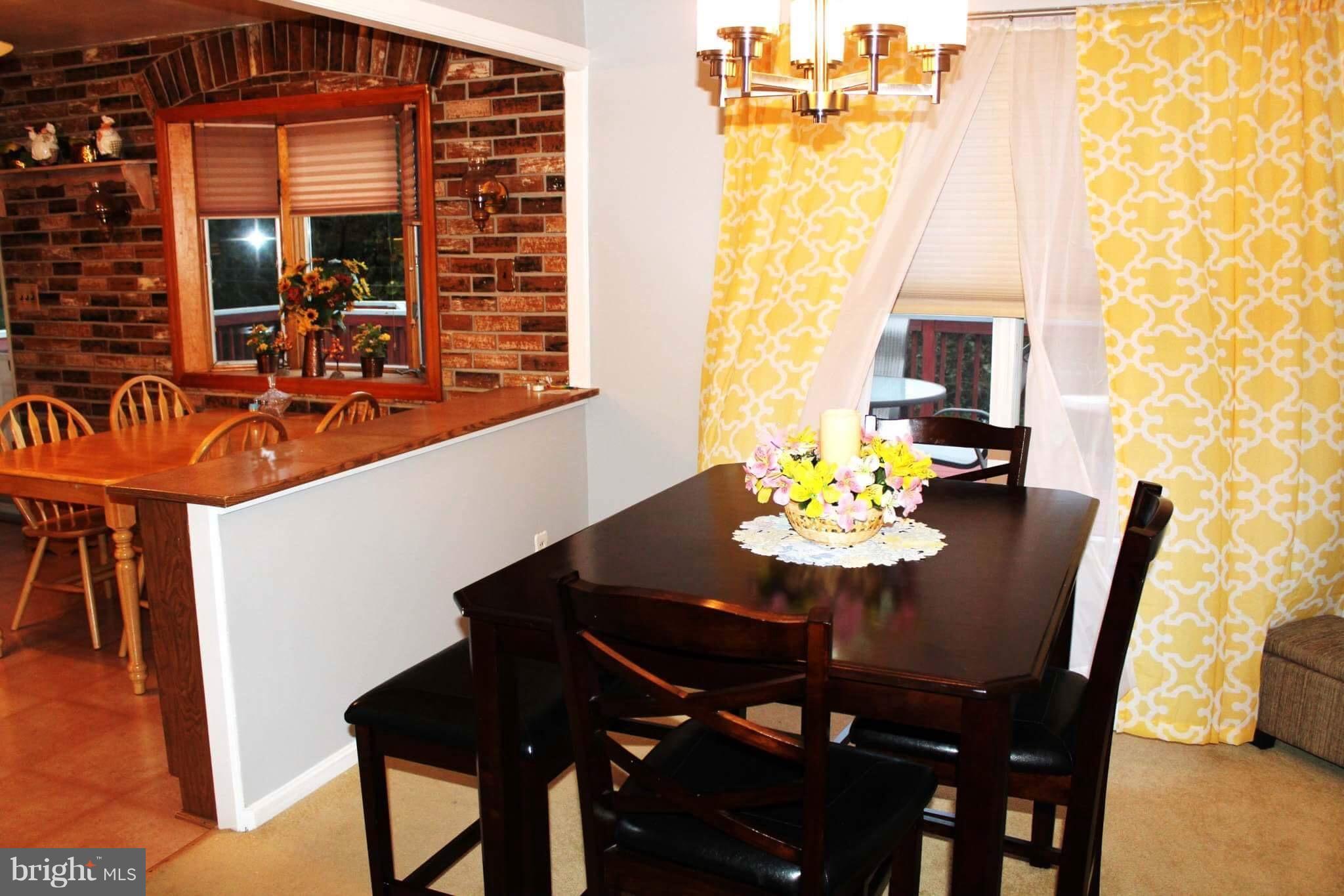 1507 National Road Baltimore, MD 21237 - Photo 8 of 30 a view of a dining room with furniture and chandelier