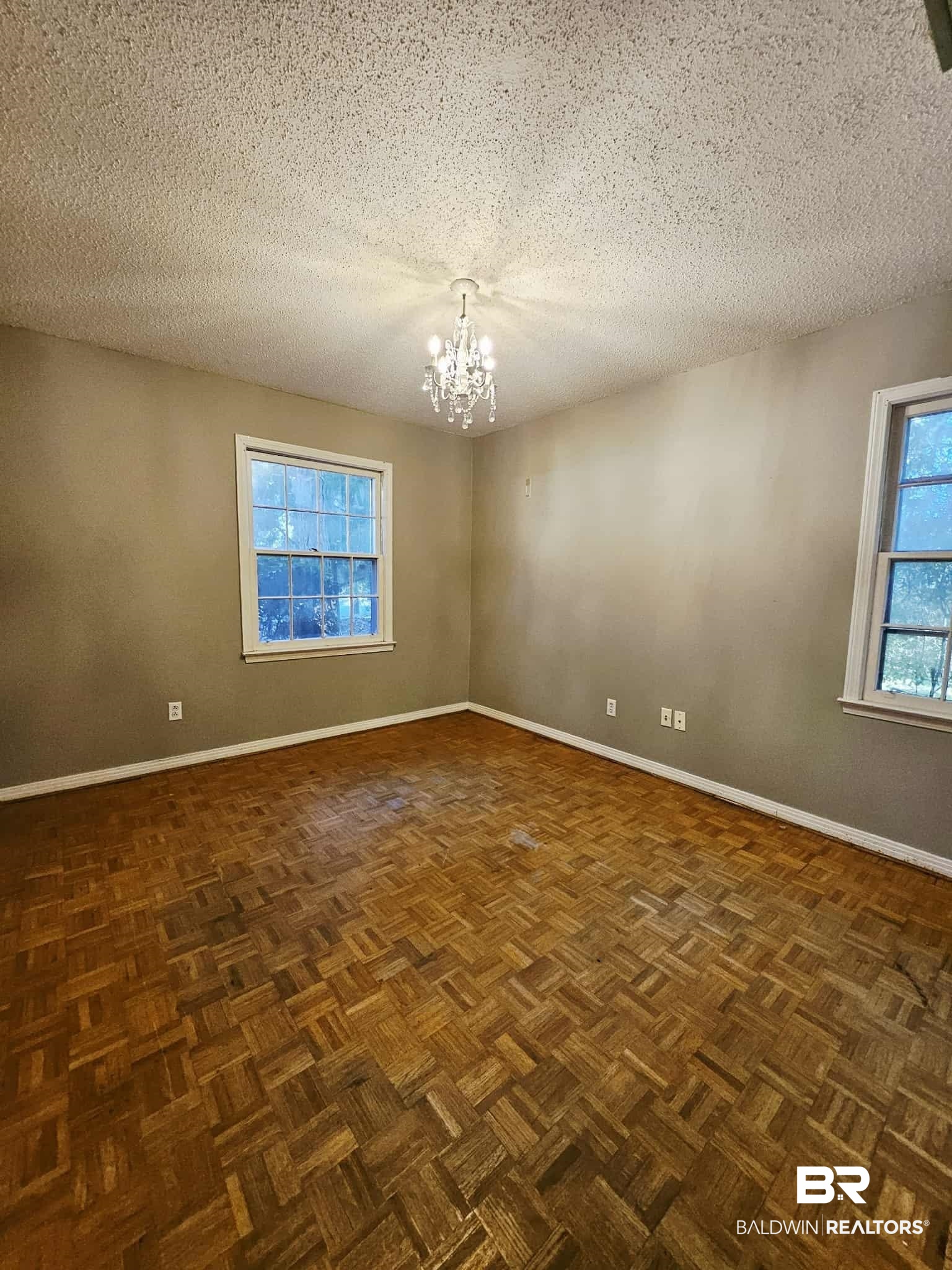 324 Vanderbilt Drive Mobile, AL 36608 - Photo 10 of 17 Unfurnished room with a chandelier and a textured ceiling