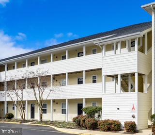 17293 King Phillip Way, Unit 10 Lewes, DE 19958 - Photo 13 of 14 a front view of a house with a yard