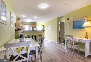 17293 King Phillip Way, Unit 10 Lewes, DE 19958 - Photo 3 of 14 a view of a dining room with furniture and wooden floor