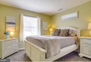 a bedroom with a bed and a dresser