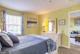 17293 King Phillip Way, Unit 10 Lewes, DE 19958 - Photo 7 of 14 a bedroom with a bed and a window