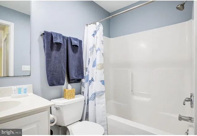 a white toilet sitting next to a bathroom sink