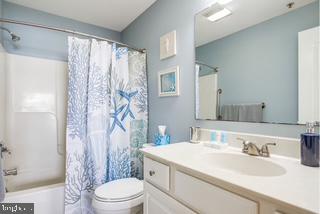 17293 King Phillip Way, Unit 10 Lewes, DE 19958 - Photo 9 of 14 a bathroom with a sink a toilet and shower