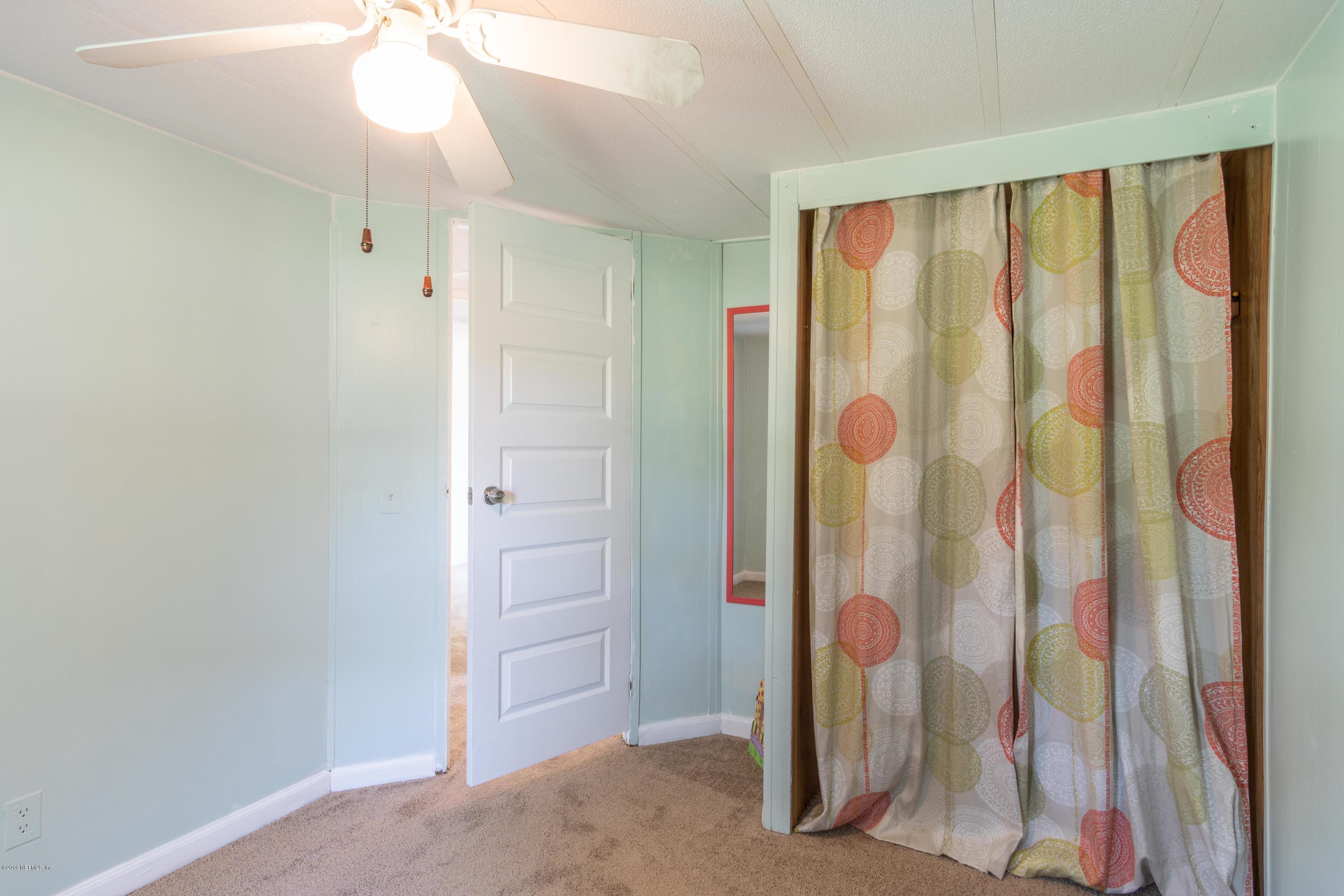 54256 Dornbush Road Callahan, FL 32011 - Photo 16 of 60 a view of a bathroom with a shower curtain
