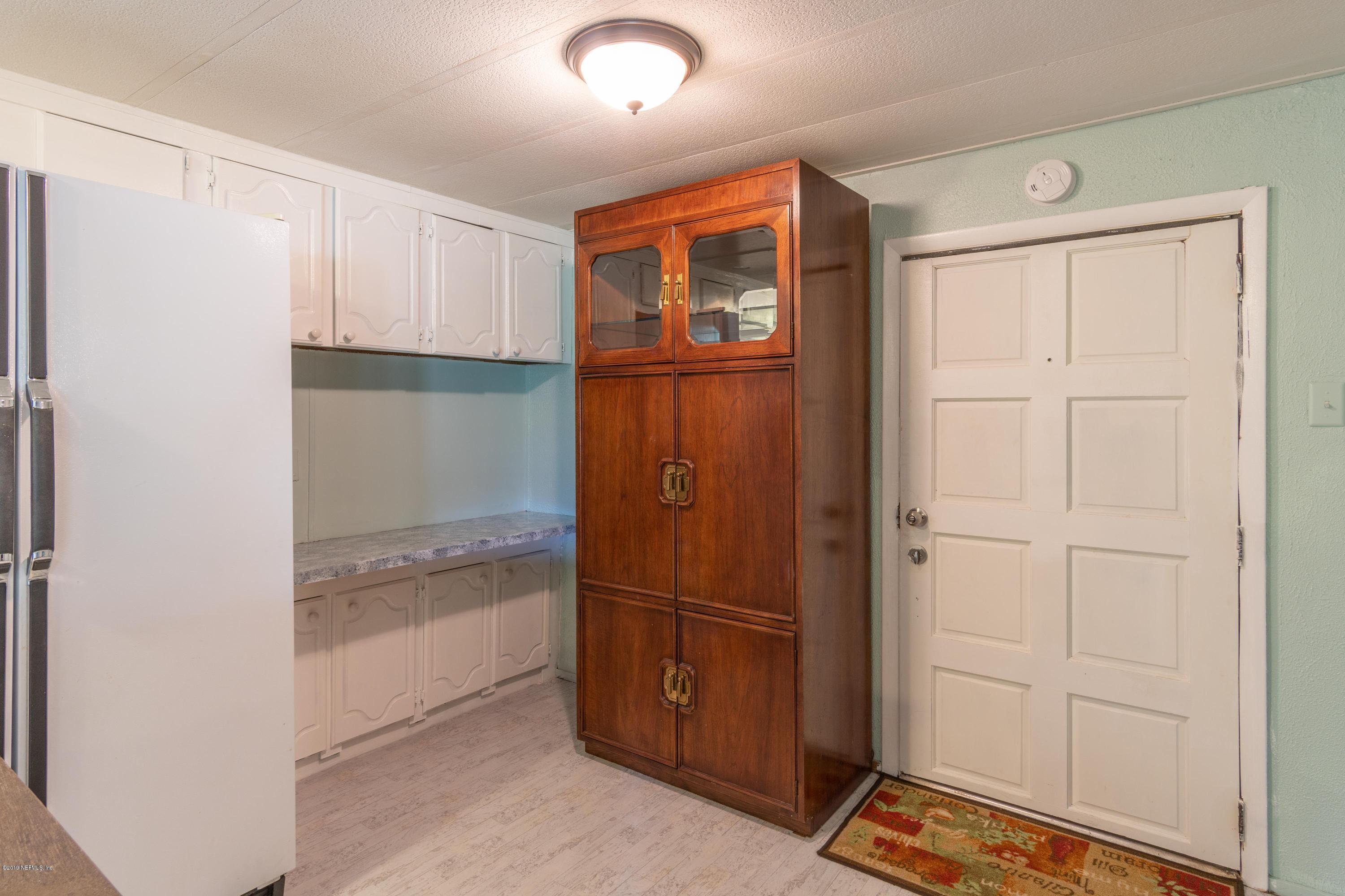 54256 Dornbush Road Callahan, FL 32011 - Photo 28 of 60 a view of walk in closet with empty racks