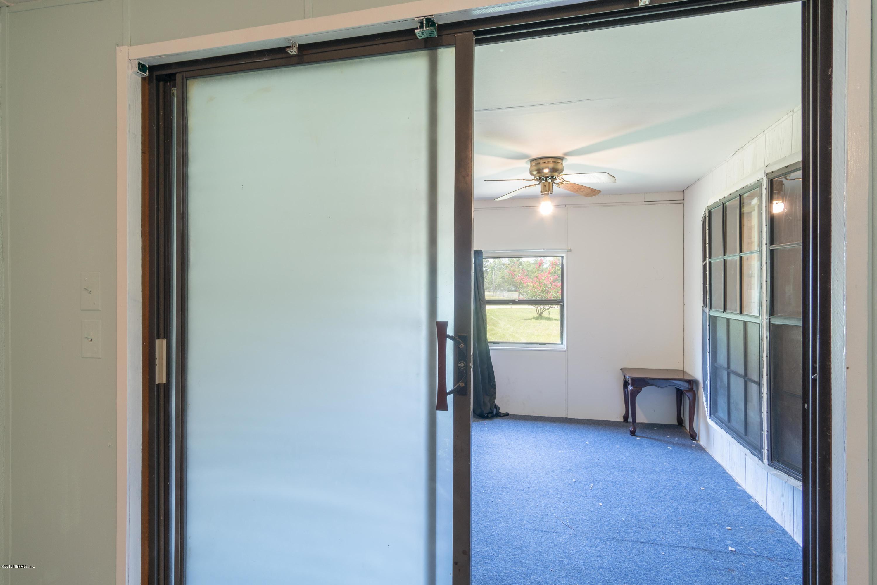 54256 Dornbush Road Callahan, FL 32011 - Photo 31 of 60 a view of a hallway with wooden floor and a window