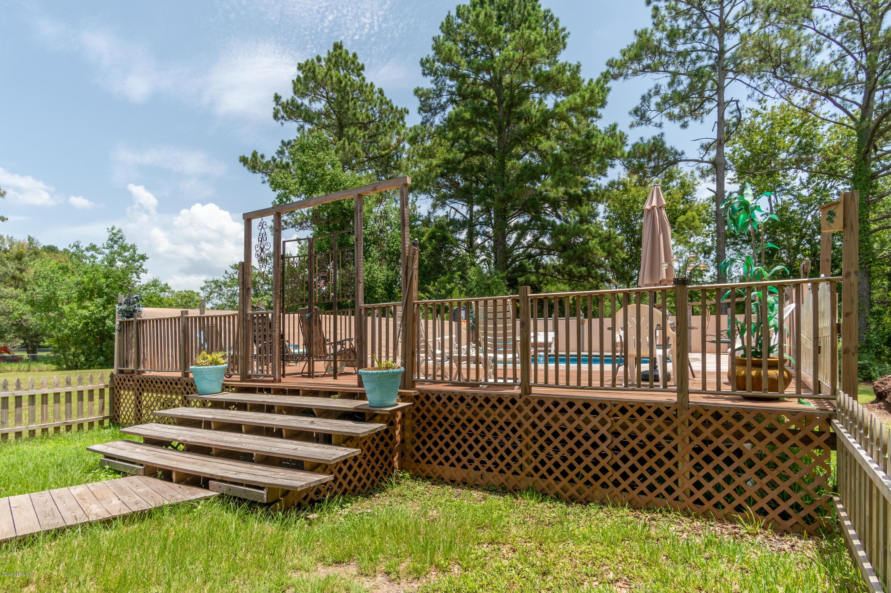 54256 Dornbush Road Callahan, FL 32011 - Photo 47 of 60 a view of a wooden deck and a yard