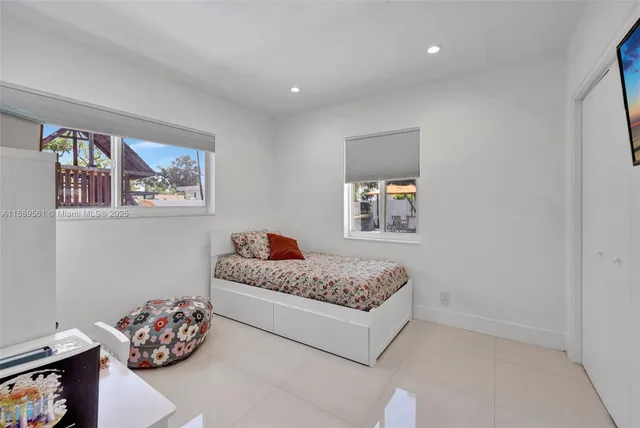 a bedroom with a bed and a window