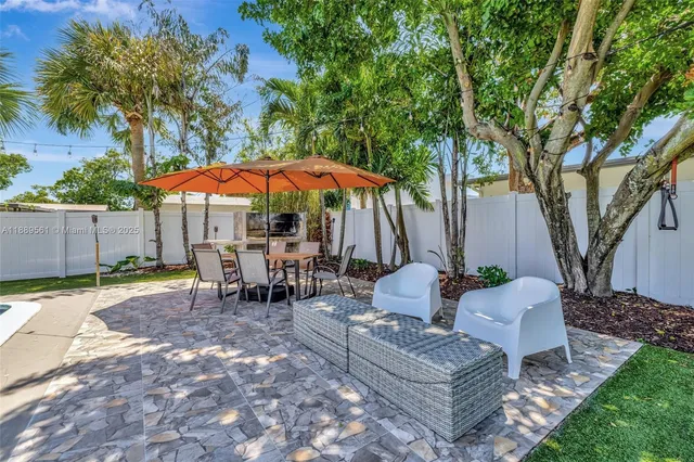 a view of a backyard with a sitting area and furniture