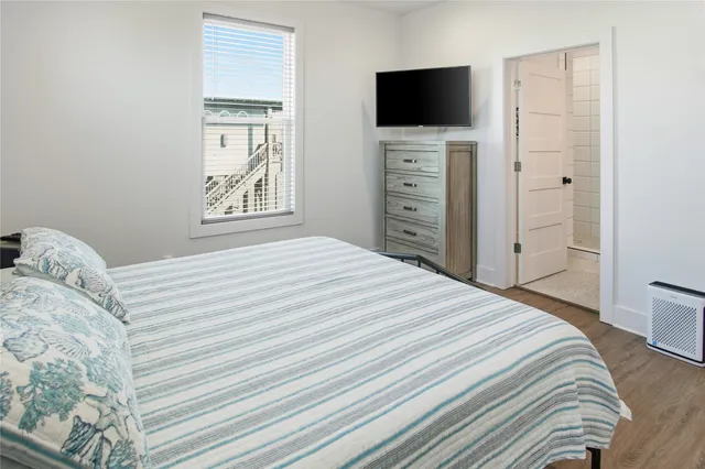 a bedroom with a bed and a flat screen tv