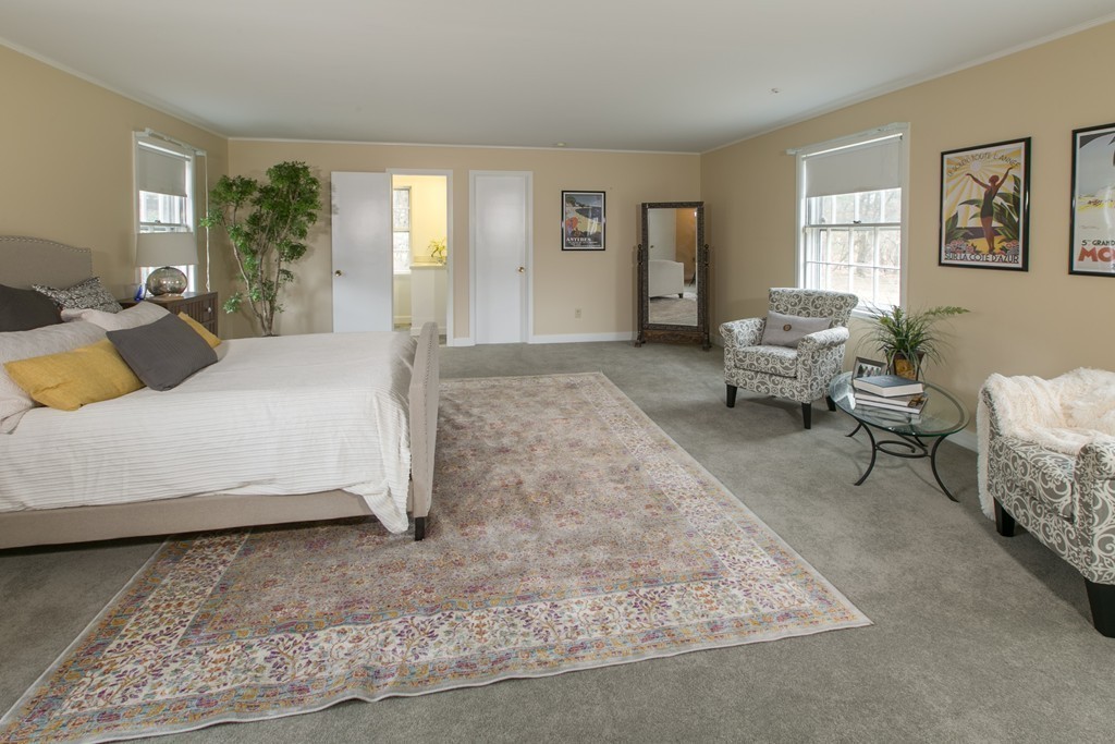 111 Barretts Mill Road Concord, MA 01742 - Photo 15 of 29 a bedroom with a bed and glass window