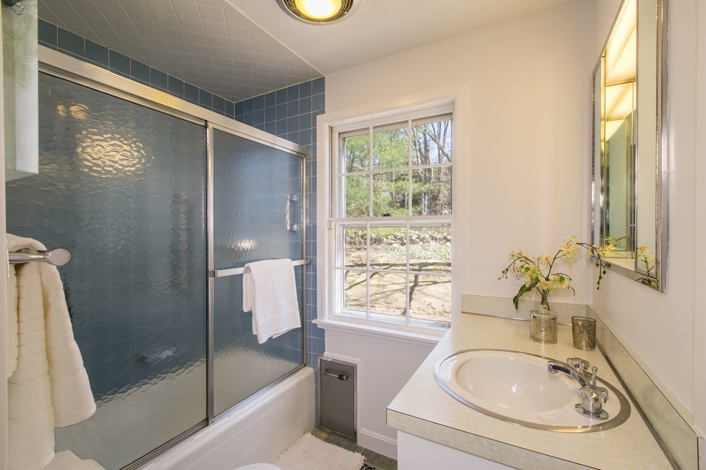 111 Barretts Mill Road Concord, MA 01742 - Photo 16 of 29 a bathroom with a sink a bathtub and next to a window