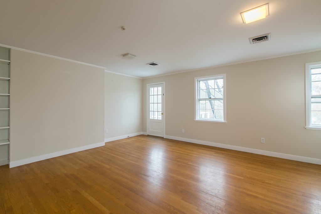 111 Barretts Mill Road Concord, MA 01742 - Photo 17 of 29 an empty room with wooden floor and windows