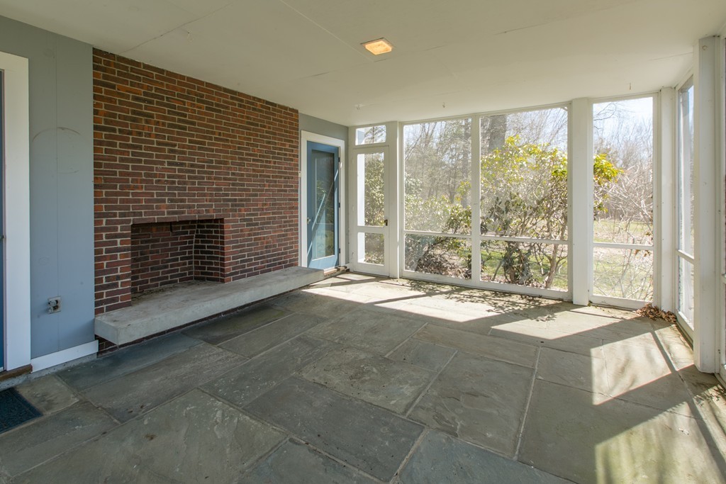 111 Barretts Mill Road Concord, MA 01742 - Photo 20 of 29 a view of an empty room with a fireplace and a large window