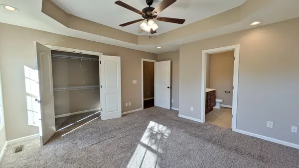 a view of a livingroom with a ceiling fan and window