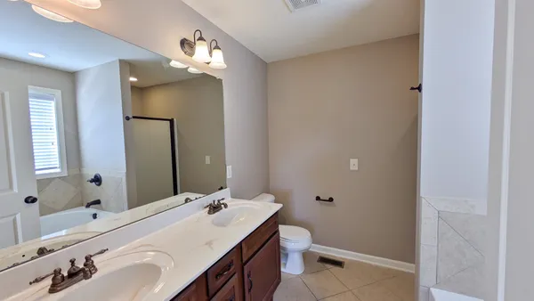 a bathroom with a tub shower and a sink