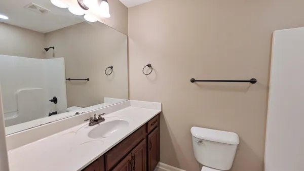 a view of a livingroom with a ceiling fan and window