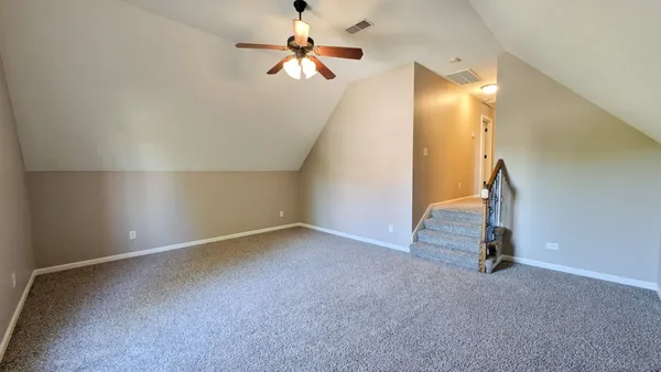 an empty room with a empty space and a ceiling fan