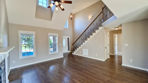 a view of entryway and hall with wooden floor