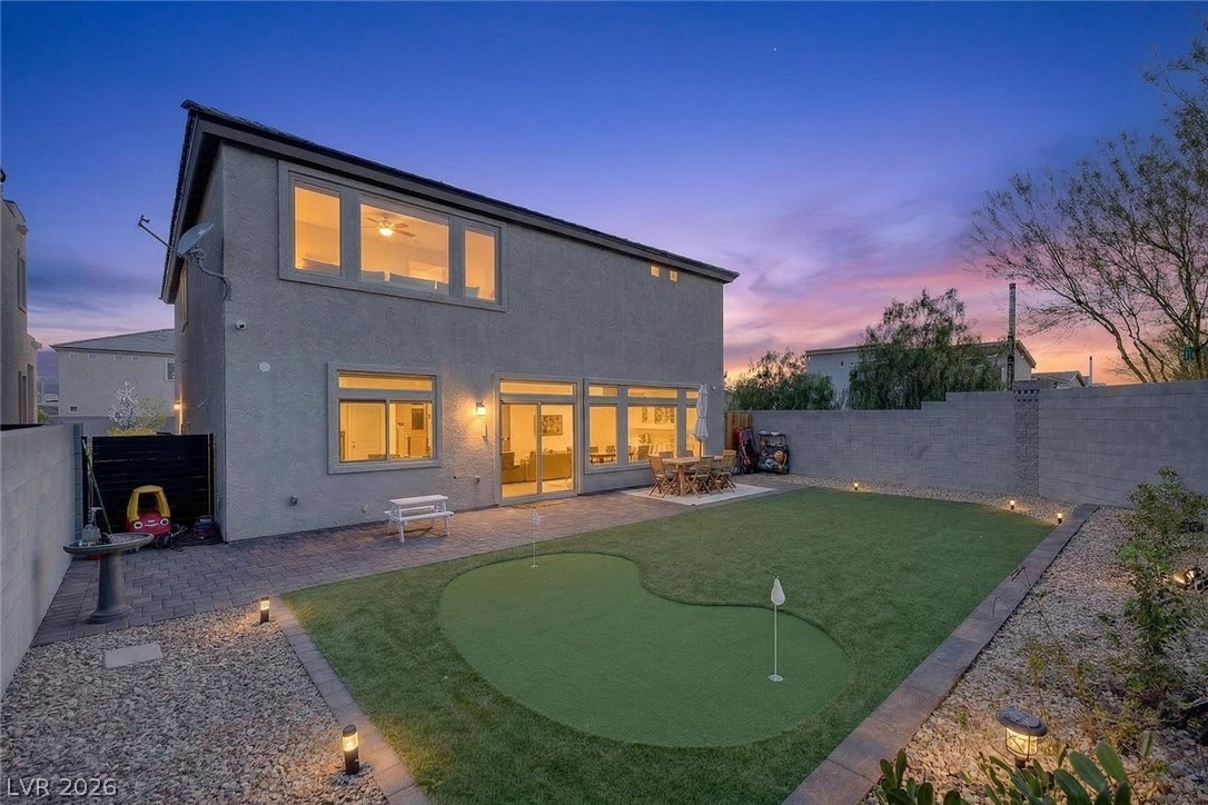 10446 Emerald Rye Street Las Vegas, NV 89183 - Photo 31 of 37 A private backyard oasis features a custom putting green and expansive patio for outdoor entertaining.